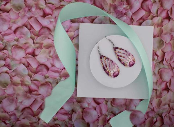 pretty pink teardrop earrings among a bed of pink petals