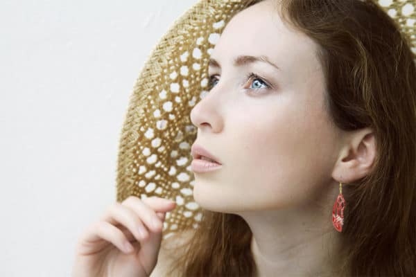 pretty red-haired woman wearing cathedral cut earrings