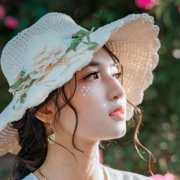 attractive Asian woman wearing wooden look teardrop earrings