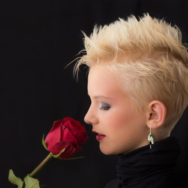 white Sakura blossom fan earrings on a beautiful blonde woman