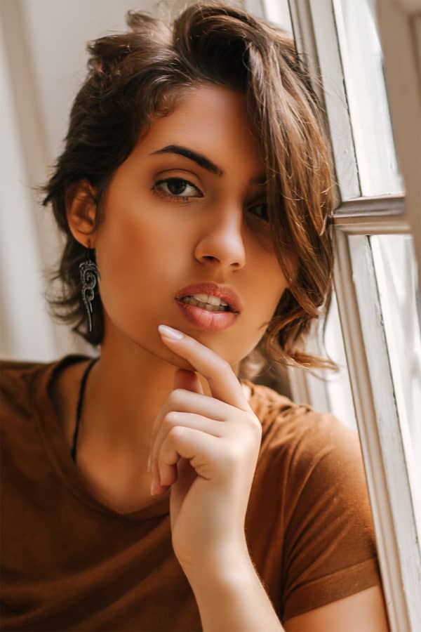 latino woman wearing edgy tribal earrings with leopard spots